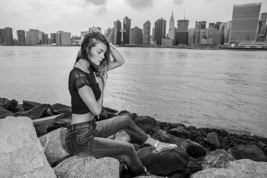 Black and white editorial portrait by the New York waterfront