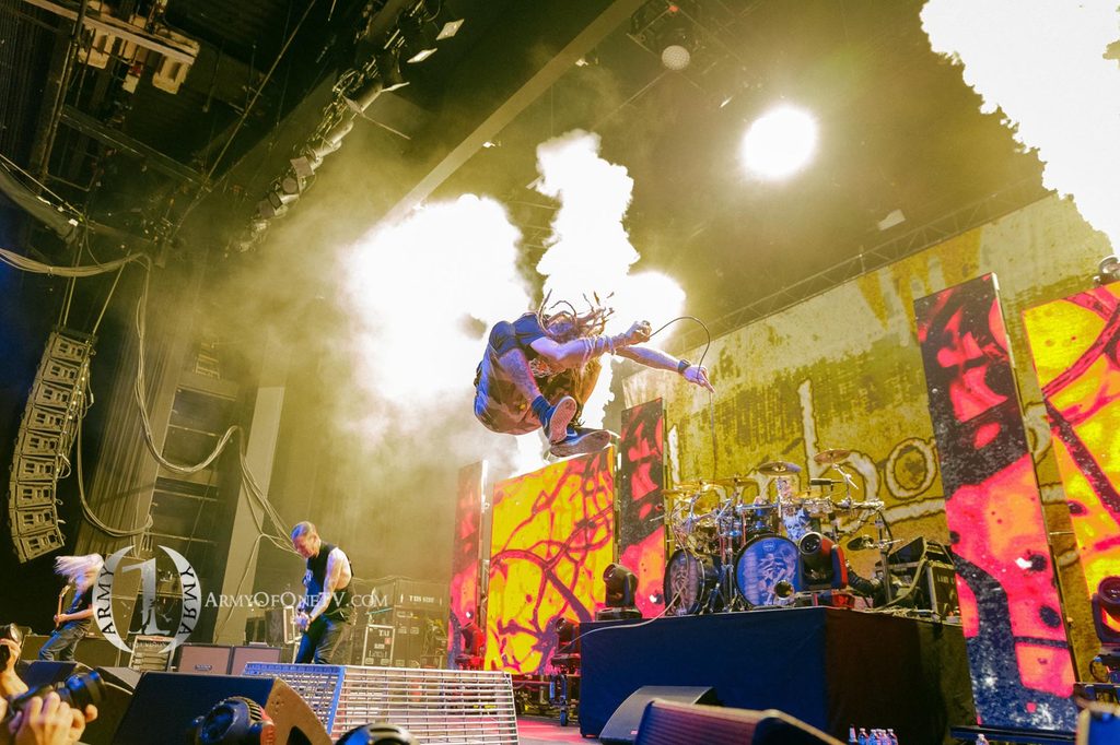 Live concert performance with stage smoke and lights