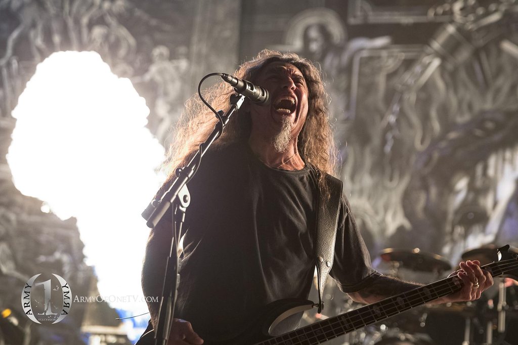 Rock musician singing and playing bass on stage