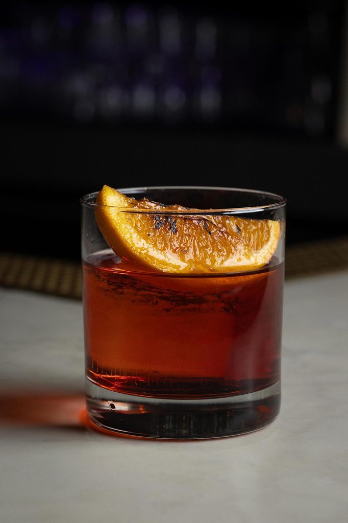 Commercial cocktail photography with orange garnish